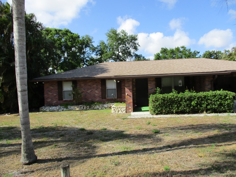 exterior front lovely brick florida pool home.